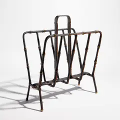 Magazine rack by Jacques Adnet, circa 1950, Leather-covered steel, brass, sold Feb 2024