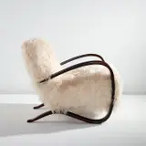 Jindrich Halabala, Armchair, model no. H-269, designed circa 1930, Stained beech, sheepskin upholstery