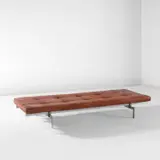 Daybed, model no. PK 80 by Poul Kjærholm, circa 1957, Chromium-plated steel, painted wood, leather upholstery, offered Dec 2024