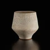 Pot with oval lip by Lucie Rie, circa 1974, Stoneware, pitted cream glaze, sold Dec 2024