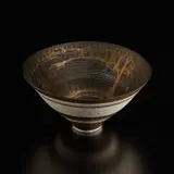 Lucie Rie, Rare footed bowl, circa 1982, Porcelain, running golden manganese glaze with bands of inlaid and sgraffito grid designs