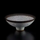 Lucie Rie, Footed bowl, circa 1982, Stoneware, pitted cream, light green, and pink glaze with manganese rim