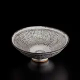 "New Knitted" footed bowl by Lucie Rie, circa 1981, Stoneware, white dolomite glaze with radiating inlaid manganese design, sold Dec 2024
