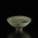 Footed bowl by Lucie Rie, circa 1972, Stoneware with manganese speckle, layered manganese and pitted green glaze, sold Dec 2024