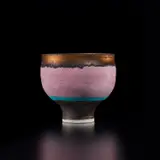 Footed bowl by Lucie Rie, circa 1978, Porcelain, diagonal inlay beneath pink glaze with turquoise and golden manganese bands, sold Dec 2024
