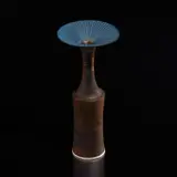 Vase with flaring lip by Lucie Rie, 1978, Porcelain, golden manganese and matte blue glaze with sgraffito design on rim, sold Dec 2024