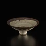 Lucie Rie, Footed bowl, circa 1982, Stoneware, pitted light green and lavender glaze with running golden manganese rim