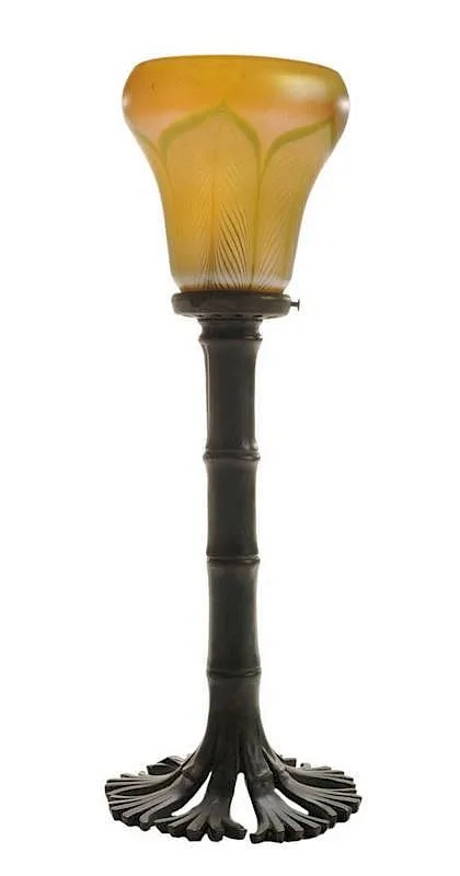 Patinated Bronze and by Tiffany Studios, Favrile Glass Candlestick Lamp  base stamped "Tiffany Studios New York" and "1205", sold Sep 2014