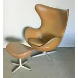 ; Fritz Hansen Egg Chair & Ottoman by Arne Jacobsen, Brown upholstered egg chair and ottoman designed by Arne Jacobsen for Fritz Hansen, sold Dec 2016