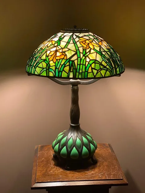 Daffodil Table Lamp by Tiffany Studios, Leaded glass shade with blown out glass and bronze base, sold May 2020