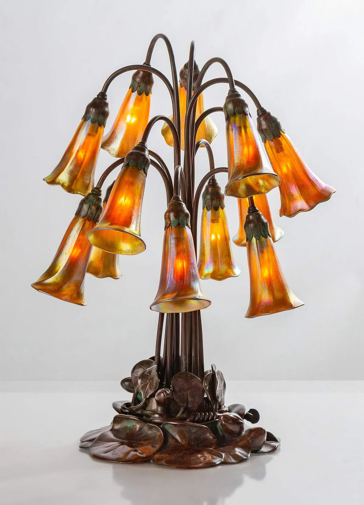 Twelve-Light Lily by Tiffany Studios, 1905, favrile glass, sold May 2024