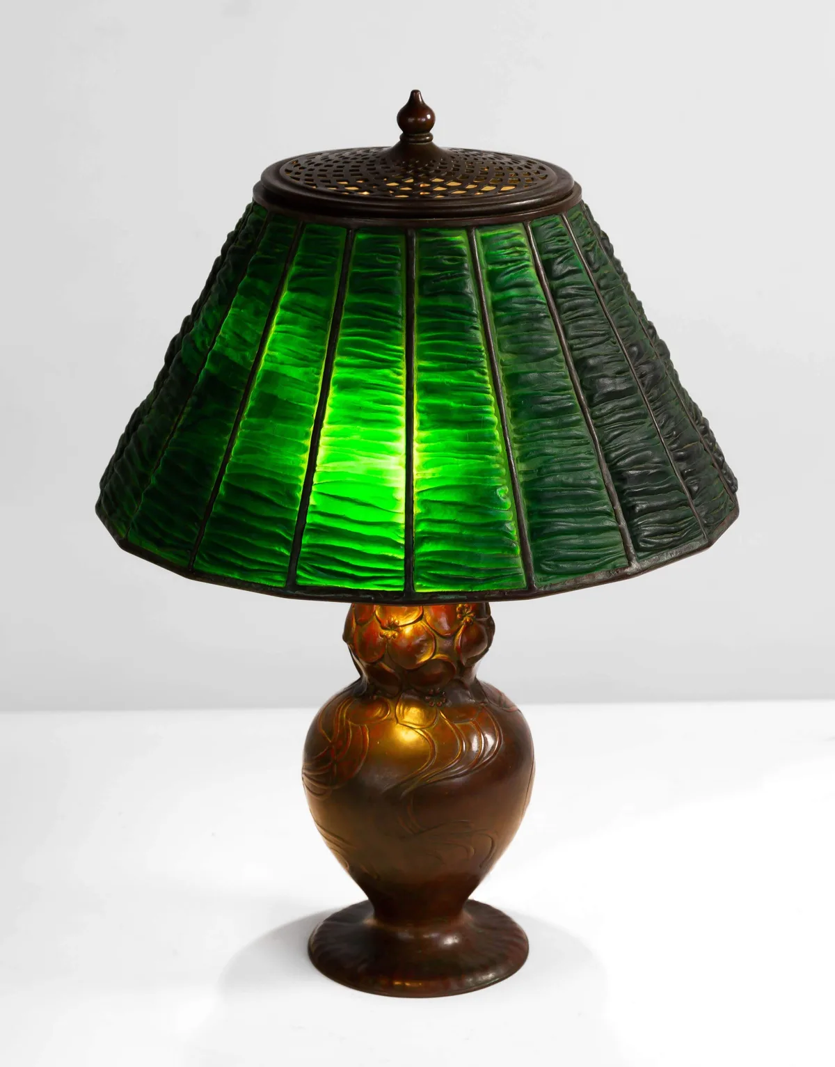 Linen Fold Table Lamp by Tiffany Studios, circa 1910, Leaded glass and patinaed bronze, sold Mar 2023