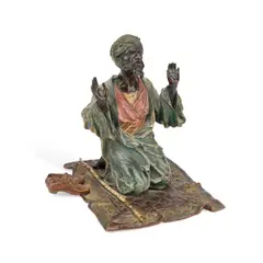 Franz Bergman, A Cold-Painted Bronze Figure Of An Arab At Prayer, sculpture