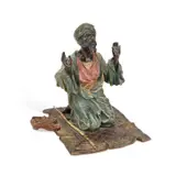 Franz Bergman, A Cold-Painted Bronze Figure Of An Arab At Prayer, sculpture