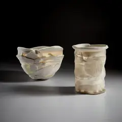 Two "Light Gatherers" by Rudolf Staffel, circa 1985, Unglazed porcelain, handbuilt from overlapping elements, sold Jun 2022
