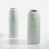 Two tall lidded jars by Edmund de Waal, circa 1997, Porcelain, celadon glaze, sold Dec 2022