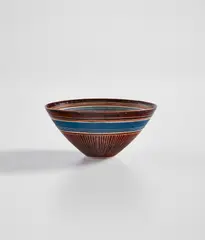 Lucie Rie, Conical bowl, circa 1960, Porcelain, manganese glaze with sgraffito on exterior, yellow glaze with inlaid design on the interior, horizontal blue band repeated inside and outside