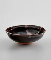 Dish by Shoji Hamada, circa 1960, Stoneware, tenmoku and poured-iron glazes, sold Feb 2021