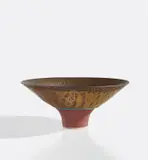 Footed bowl by Lucie Rie, circa 1980, Porcelain, bright golden manganese glaze, terracotta foot and well and a turquoise ring repeated inside and out, sold Jun 2021