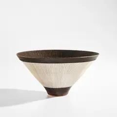 Conical bowl by Lucie Rie, circa 1978, Porcelain with manganese glaze, radiating inlaid and sgraffito design, sold Dec 2021