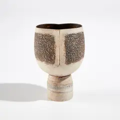 Hans Coper, Pot on cylindrical foot with vertical impression, circa 1975, Stoneware, layered white porcelain slips and engobes over a body with textured and incised linear designs, the interior with manganese glaze