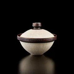 Covered bowl by Lucie Rie, circa 1958, Porcelain, radiating inlaid design and interior with matching sgrafitto design, manganese glaze on the interior, lip, an, sold Jul 2020