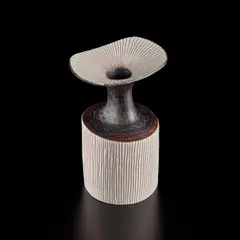 Vase with flaring lip by Lucie Rie, circa 1974, Porcelain, manganese glaze on shoulder and neck, inlaid lip and body, sold Jul 2020