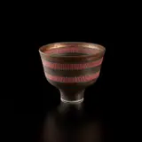 Footed bowl by Lucie Rie, circa 1978, Porcelain, golden manganese glaze, two terracotta bands crossed with vertical sgraffito lines, and turquoise ring in the, sold Jul 2020