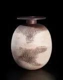 Hans Coper, Ovoid pot with disc, circa 1965, Stoneware, layered white porcelain slips and engobes over a body with textured and incised linear designs, the neck and disk with manganese glaze