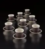 Lucie Rie and Hans Coper, Set of eight cups and saucers, circa 1952, Stoneware, white and manganese glaze with sgraffito design