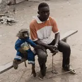 Pieter Hugo, Dayaba Usman with the monkey Clear, Nigeria from The Hyena and Other Men
