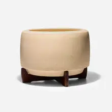 Planter, model CP-17 by John Follis and Rex Goode, c. 1960, glazed stoneware, walnut, sold Aug 2026