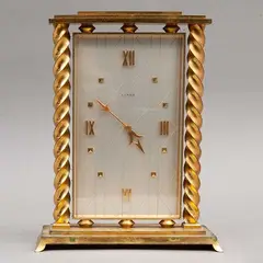 Reloj de Mesa, SUIZA, SIGLO XX, Bronce dorado, carátula metálica, números romanos y tachones, forma cuadrangular, laterales a manera de columnas salomónicas