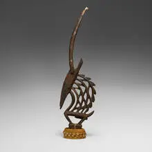 Bamana, Chi Wara (antelope headdress), carved wood, metal, cloth, cowry shells, rope, wicker