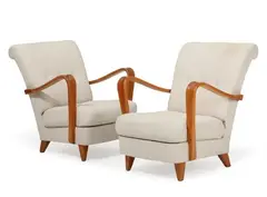 A pair of easy chairs with elm legs and armrests, upholstered with light wool by Scandinavian furniture design, sold Sep 2026