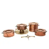 Jens Quistgaard, A copper and brass fondue pot with burner, three saucepans and a brass trivet