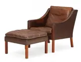 Børge Mogensen, Armchair and footstool with teak legs, seat, back, sides and loose cushions upholstered in patinated brown leather