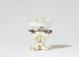 Meissen Royal Porcelain Manufactory, A Meissen porcelain salt cellar with three sculpted female heads and a small chinoiserie