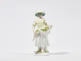 Meissen Royal Porcelain Manufactory, A Meissen porcelain figure of a gardener with a straw hat and vegetables