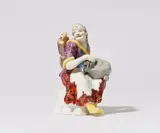 Meissen Royal Porcelain Manufactory, A rare Meissen porcelain figure of an old beggar woman with a hurdy-gurdy
