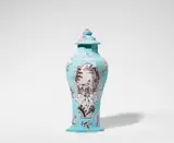 Cornelis Funcke, A Berlin faience vase and cover with Chinoiserie decor, Slender baluster-form vase of octagonal section with original cover. Rim chips, a glaze chip to the finial