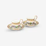 A pair of KPM Berlin porcelain cups and saucers with passionflower wreaths by Königliche Porzellanmanufaktur Berlin Kpm, Model no. 755. Blue sceptre mark with enamel blue dash, red painter's marks, press marks. Minor wear to the gilding. Cup, sold Apr 2026