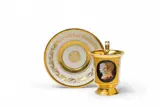 Königliche Porzellanmanufaktur Berlin Kpm, A KPM Berlin porcelain cup with a faux cameo double-portrait and saucer