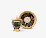 Königliche Porzellanmanufaktur Berlin Kpm, A KPM Berlin porcelain cup and saucer with grotesques on black ground