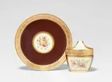 A KPM Berlin porcelain cup and saucer with floral motifs by Königliche Porzellanmanufaktur Berlin Kpm, Model no. 1308. With brown ground. Blue sceptre mark with enamel grey dash below, iron red 21, incised marks. Cup, sold Apr 2026