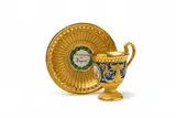 Königliche Porzellanmanufaktur Berlin Kpm, A KPM Berlin commemorative porcelain cup with grotesques and saucer