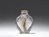 An etched glass bottle and stopper with lily motifs by Emile Gallé by Émile Gallé, sold Nov 2024