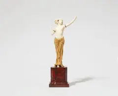 Ferdinand Preiss, A chryselephantine figure of Salomé dancing, Ivory with minor polychromy, two small faceted red garnets, gilded bronze/metal, red marble base. Unsigned. One index finger lost. H