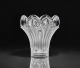 Lalique Verrerie, An Esna vase
Lalique, Wingen-sur-Moder, 1990s/early 2000s., Clear mould-pressed glass, patinated. Etched signature Lalique ® France. Faint scratches to the underside. H 21, D c
