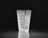Lalique Verrerie, A Senlis vase
Lalique, Wingen-sur-Moder, designed in 1961., Clear mould-pressed glass, patinated, matte etched. Etched signature Lalique France. Faint scratches to the base. H